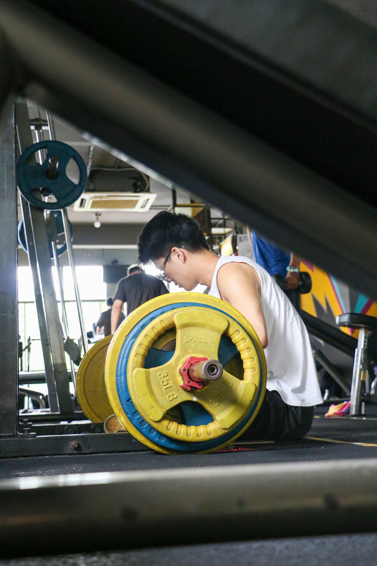 Close-up of weight plates on the training floor at Blitz Gym SS15